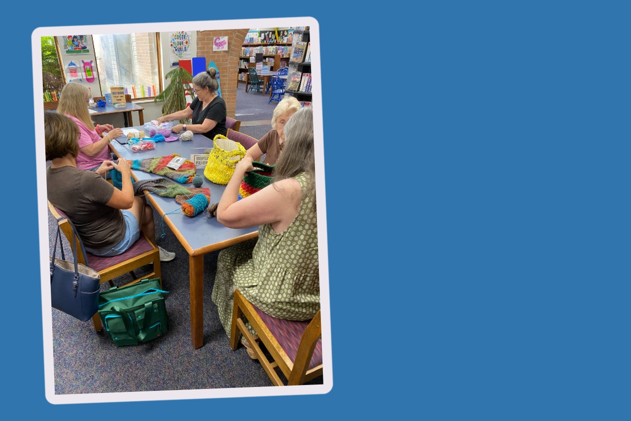 A group of women knitting and crocheting at the Greenfield Branch