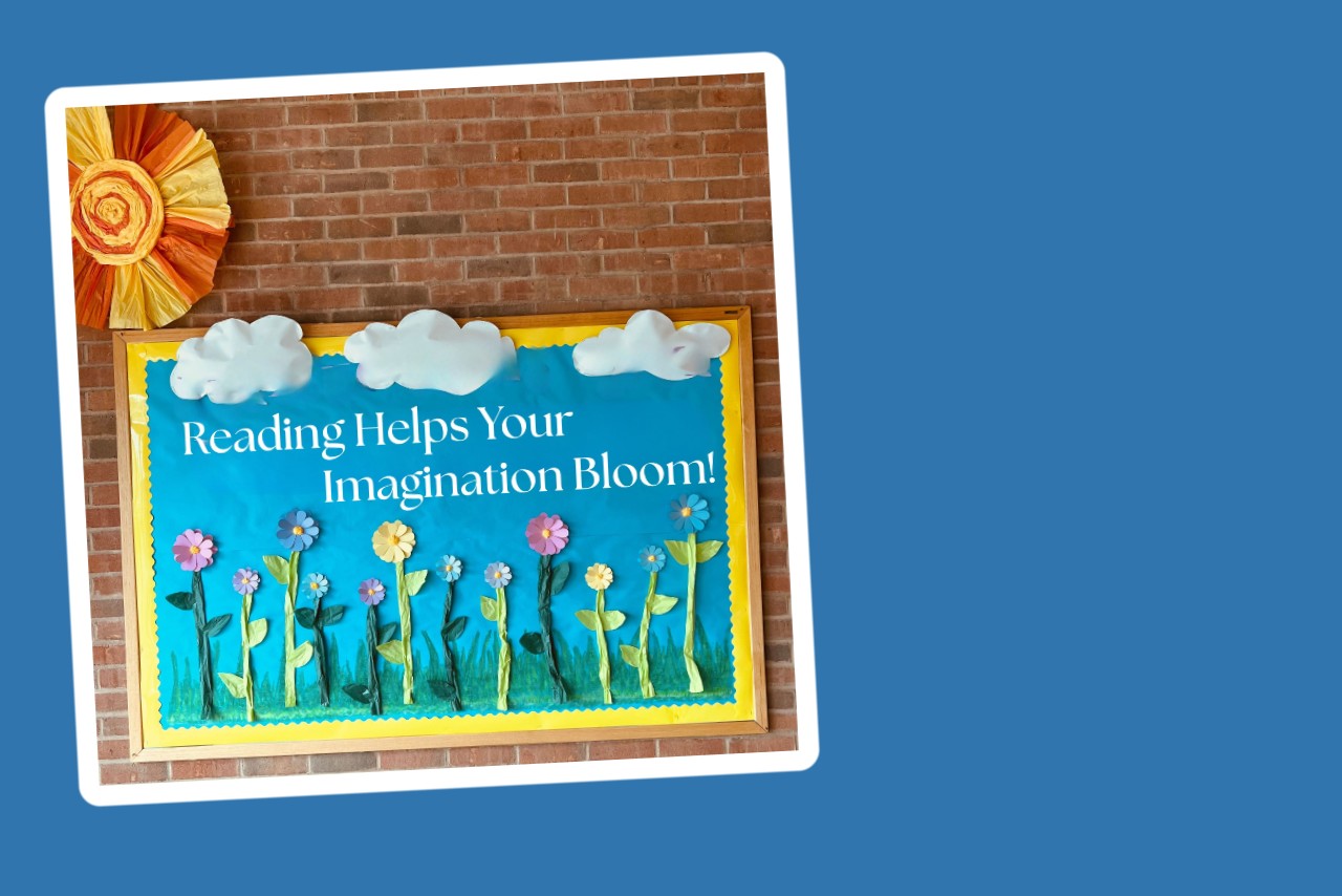 A bulletin board with flowers and the phrase: Reading Helps Your Imagination Bloom